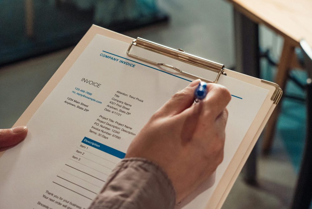 Close-Up Shot of a Person Holding a Clipboard